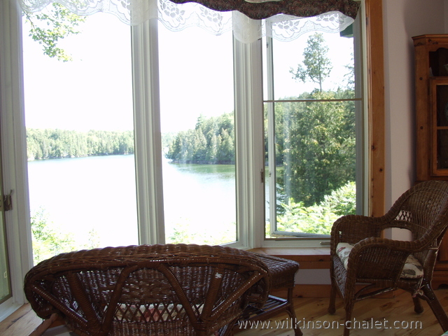 Cottage dining room nook overlooking Malone Bay,
       Lac des trente et un milles (31 miles lake),
       Bouchette, Quebec